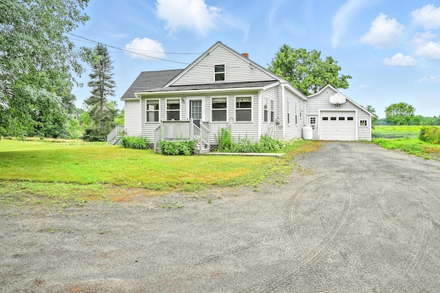 23 W St, Benton, ME 04901 - view of front facade with an outdoor structure, driveway, a front yard, a chimney, and a garage