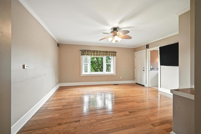 23 W St, Benton, ME 04901 - spare room featuring ornamental molding, a ceiling fan, and light wood-style flooring