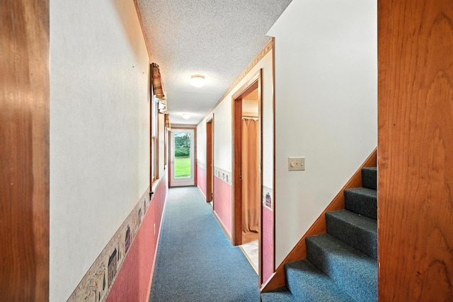 23 W St, Benton, ME 04901 - hallway featuring a textured ceiling, carpet floors, and stairs