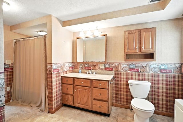 23 W St, Benton, ME 04901 - full bath with vanity, a wainscoted wall, a shower with shower curtain, a textured ceiling, and tile walls