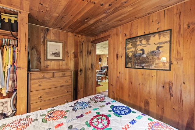 199 Peace Pipe Dr, Litchfield, ME 04350 - bedroom featuring wood ceiling and wood walls