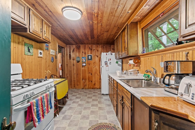 199 Peace Pipe Dr, Litchfield, ME 04350 - kitchen with white appliances, wood ceiling, wood walls, light countertops, and light flooring