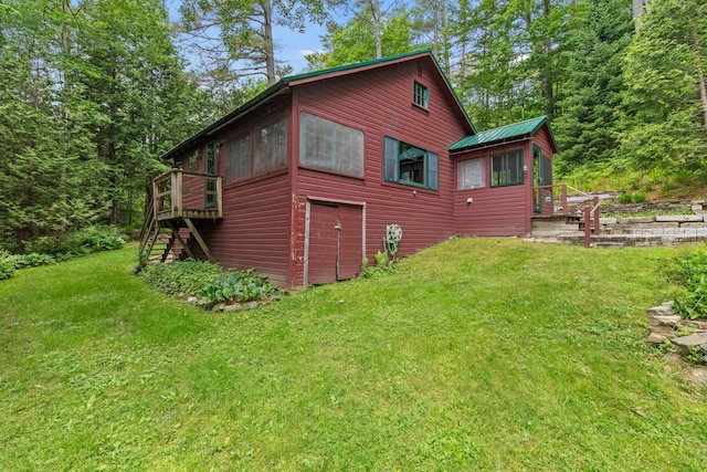 199 Peace Pipe Dr, Litchfield, ME 04350 - view of home's exterior with stairs, a deck, and a yard