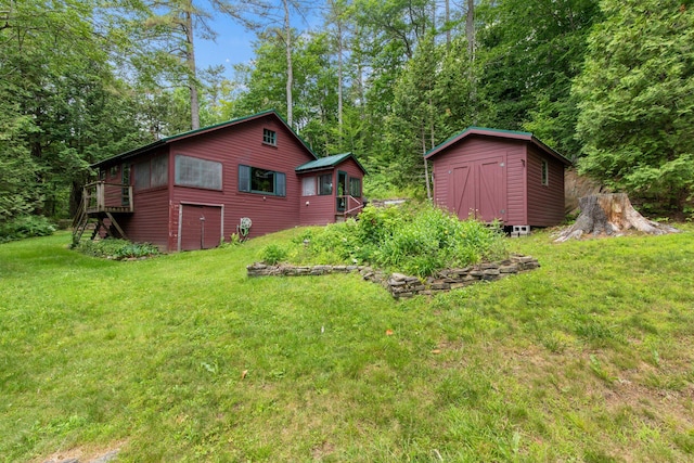 199 Peace Pipe Dr, Litchfield, ME 04350 - view of grassy yard featuring a storage unit, stairway, and a wooden deck