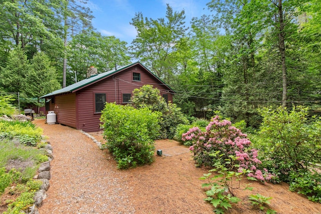 199 Peace Pipe Dr, Litchfield, ME 04350 - view of side of home with a chimney and log veneer siding