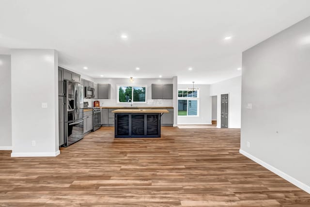 985 Main Rd, Eddington, ME 04428 - kitchen featuring stainless steel appliances, gray cabinets, recessed lighting, light wood-style floors, and decorative backsplash