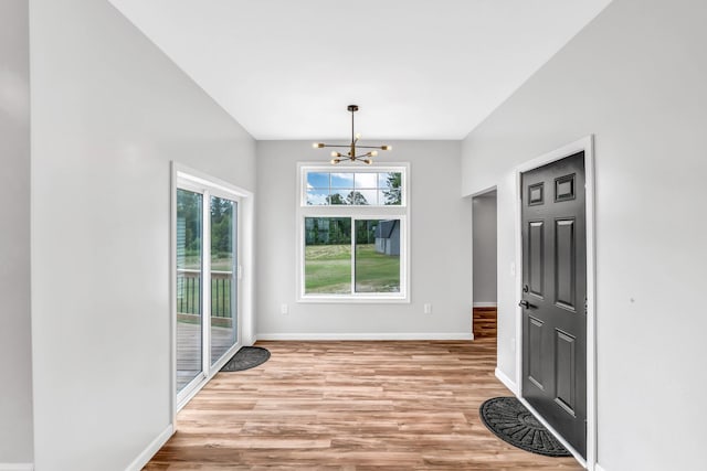 985 Main Rd, Eddington, ME 04428 - unfurnished dining area with a chandelier and light wood-style flooring