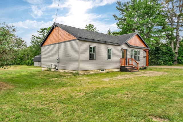 985 Main Rd, Eddington, ME 04428 - view of front of house featuring a front lawn and roof with shingles