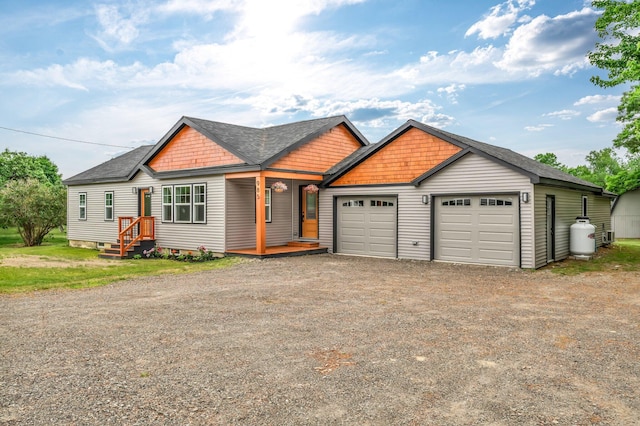985 Main Rd, Eddington, ME 04428 - view of front of property with dirt driveway, a shingled roof, and a garage