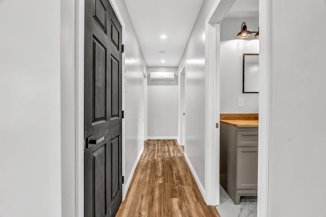 985 Main Rd, Eddington, ME 04428 - corridor with recessed lighting, a wall mounted AC, and light wood-style flooring