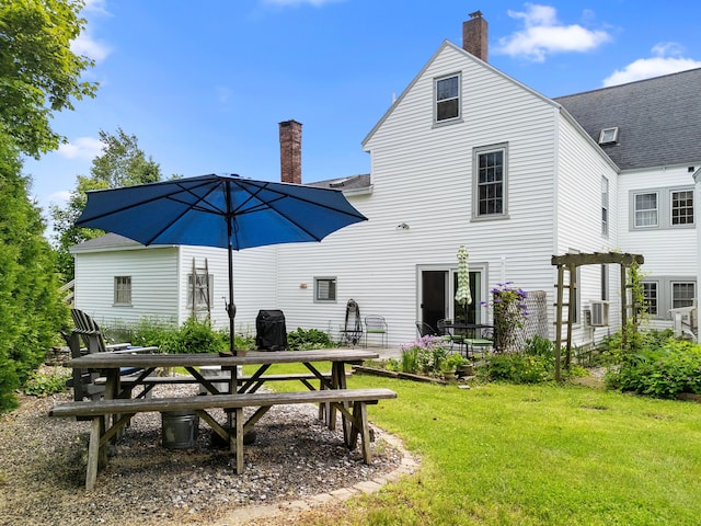 50-52 Mechanic St, Rockland, ME 04841 - rear view of house with a chimney, a lawn, a patio area, cooling unit, and roof with shingles