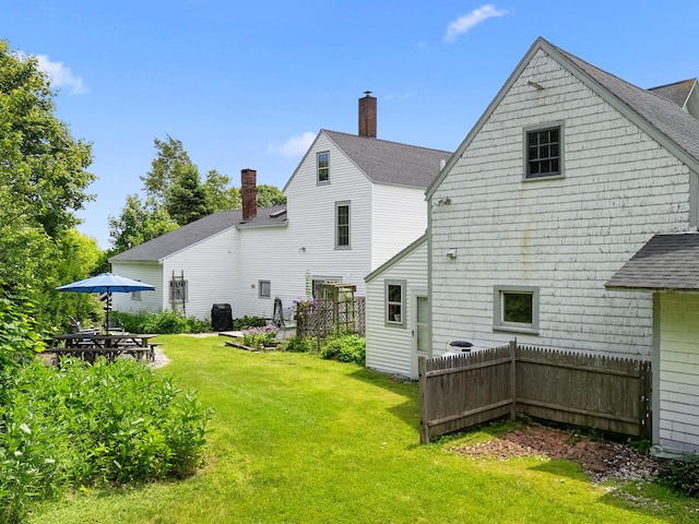 50-52 Mechanic St, Rockland, ME 04841 - back of house featuring a shingled roof and a chimney