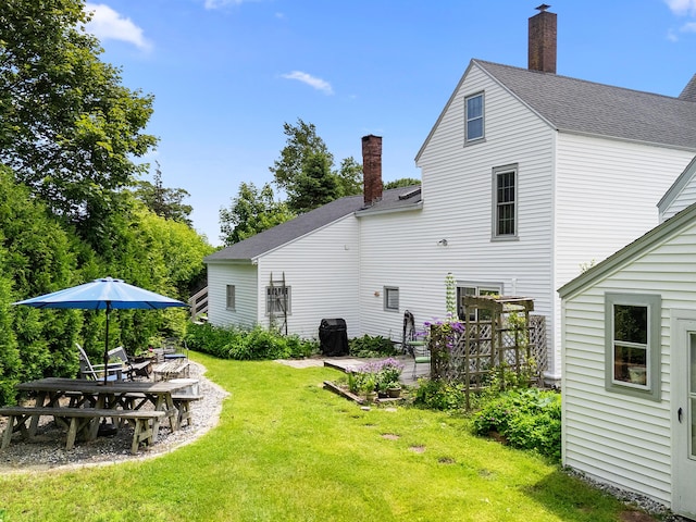 50-52 Mechanic St, Rockland, ME 04841 - rear view of property featuring a chimney, a yard, and roof with shingles