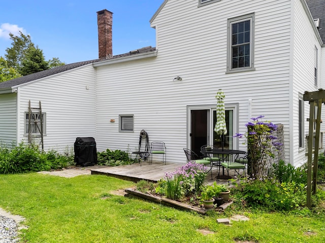 50-52 Mechanic St, Rockland, ME 04841 - rear view of property with a wooden deck, a lawn, and a chimney