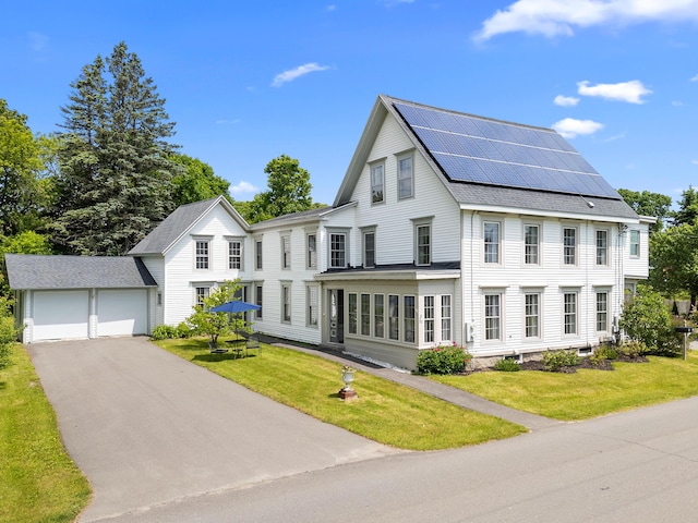 50-52 Mechanic St, Rockland, ME 04841 - view of front of house featuring roof mounted solar panels, a front yard, and a shingled roof