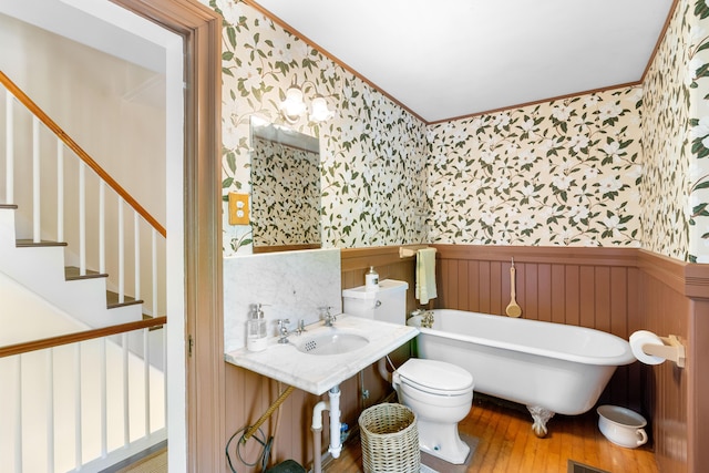 50-52 Mechanic St, Rockland, ME 04841 - bathroom with wallpapered walls, a wainscoted wall, a freestanding tub, hardwood / wood-style floors, and ornamental molding