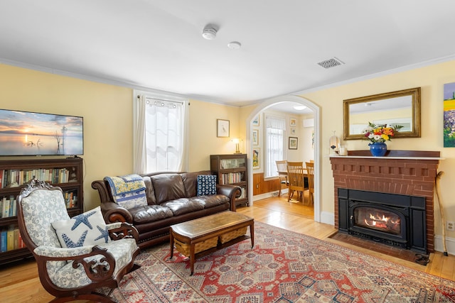 50-52 Mechanic St, Rockland, ME 04841 - living room with arched walkways, wood finished floors, ornamental molding, and a brick fireplace