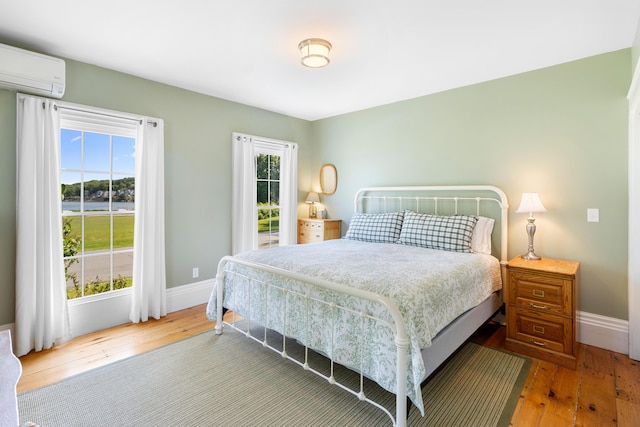 50-52 Mechanic St, Rockland, ME 04841 - bedroom featuring a wall mounted air conditioner and hardwood / wood-style floors