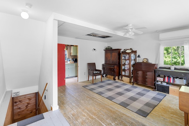 50-52 Mechanic St, Rockland, ME 04841 - sitting room with an upstairs landing, a wall unit AC, hardwood / wood-style flooring, and a ceiling fan