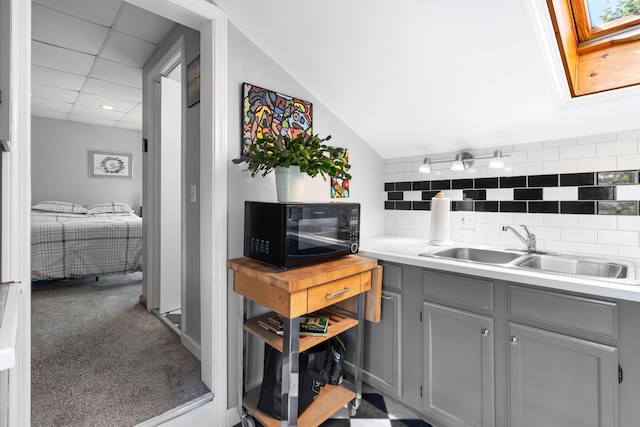 50-52 Mechanic St, Rockland, ME 04841 - kitchen featuring black microwave, gray cabinets, backsplash, light countertops, and a skylight