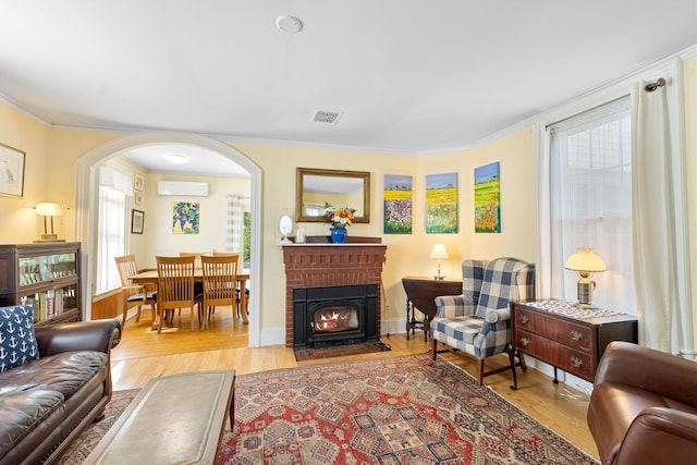 50-52 Mechanic St, Rockland, ME 04841 - living room featuring wood finished floors, plenty of natural light, arched walkways, and ornamental molding
