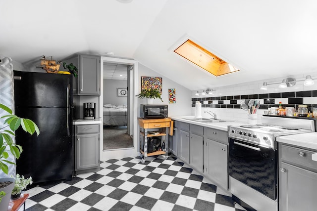 50-52 Mechanic St, Rockland, ME 04841 - kitchen with black appliances, gray cabinetry, light floors, light countertops, and lofted ceiling