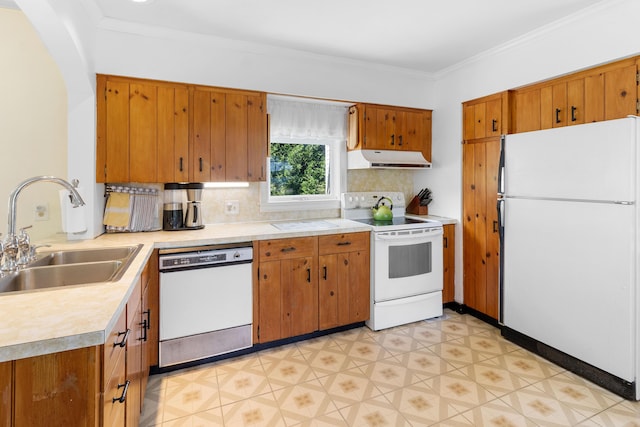 50-52 Mechanic St, Rockland, ME 04841 - kitchen with white appliances, under cabinet range hood, light countertops, brown cabinets, and decorative backsplash