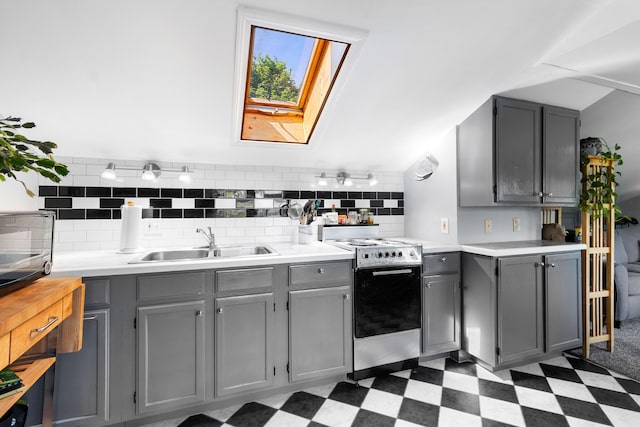 50-52 Mechanic St, Rockland, ME 04841 - kitchen featuring electric range oven, gray cabinetry, dark floors, a skylight, and light countertops