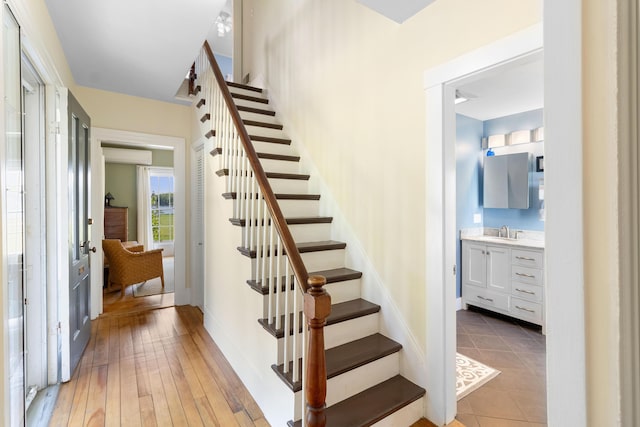 50-52 Mechanic St, Rockland, ME 04841 - staircase featuring a wall mounted AC and hardwood / wood-style floors