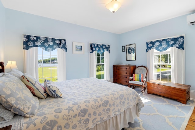 50-52 Mechanic St, Rockland, ME 04841 - bedroom with multiple windows, wood finished floors, and a wall unit AC