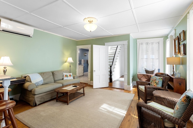 50-52 Mechanic St, Rockland, ME 04841 - living room featuring a wall mounted air conditioner, hardwood / wood-style flooring, and stairway