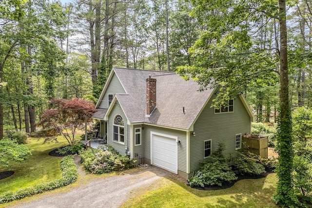 2 Falling Pines Ln, Readfield, ME 04355 - view of front of property featuring dirt driveway, a chimney, an attached garage, roof with shingles, and a front yard