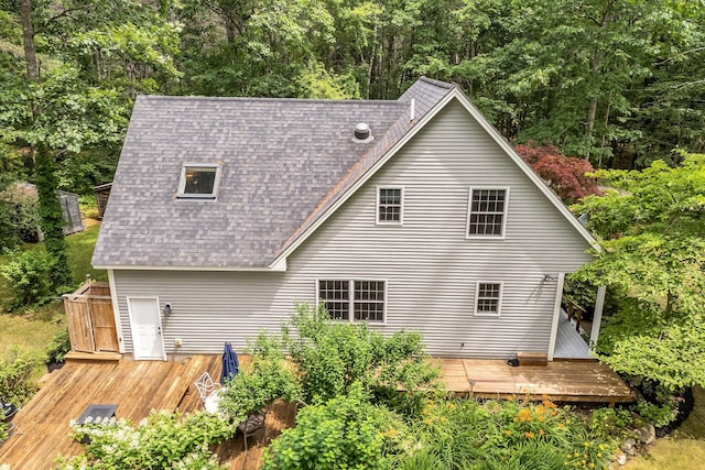 2 Falling Pines Ln, Readfield, ME 04355 - back of house with a shingled roof, a wooden deck, and a forest view