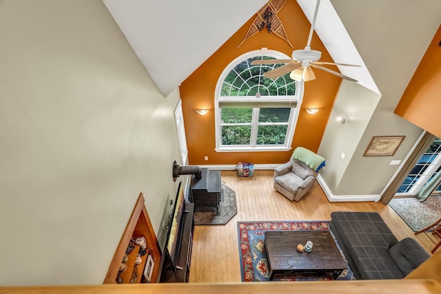 2 Falling Pines Ln, Readfield, ME 04355 - living room with wood finished floors, high vaulted ceiling, a ceiling fan, and a wood stove