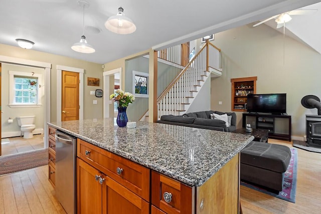2 Falling Pines Ln, Readfield, ME 04355 - kitchen featuring a center island, dark stone counters, light wood finished floors, pendant lighting, and lofted ceiling