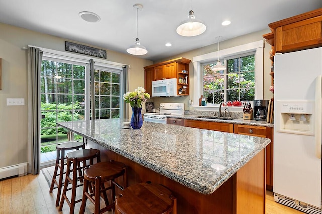 2 Falling Pines Ln, Readfield, ME 04355 - kitchen with white appliances, brown cabinetry, open shelves, a kitchen island, and light stone countertops