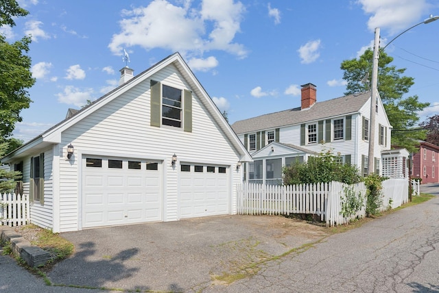 26 Grove St, Bath, ME 04530 - traditional-style house featuring a chimney, driveway, a sunroom, and a garage