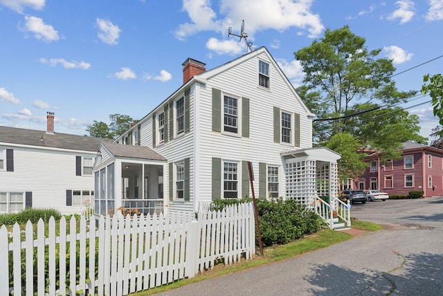 26 Grove St, Bath, ME 04530 - view of front of property with a sunroom and a chimney
