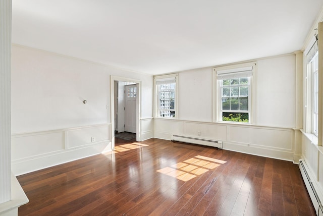 26 Grove St, Bath, ME 04530 - spare room featuring a baseboard radiator, wood finished floors, a wainscoted wall, and a decorative wall