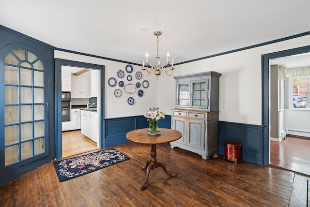 26 Grove St, Bath, ME 04530 - dining space featuring a chandelier, ornamental molding, wood finished floors, and a wainscoted wall