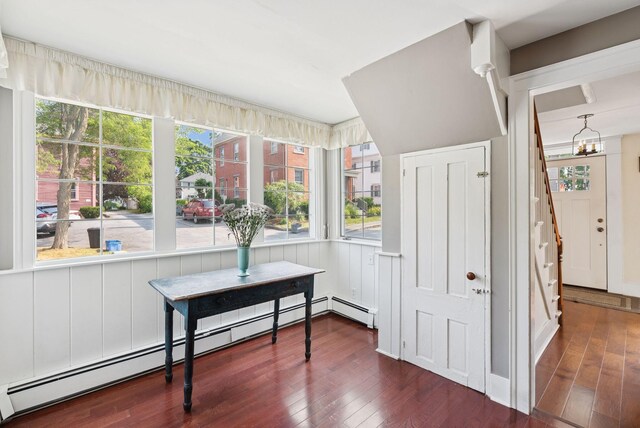 26 Grove St, Bath, ME 04530 - dining area with a baseboard radiator, wood finished floors, healthy amount of natural light, and a chandelier