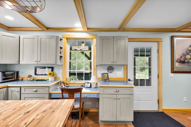 134 Powers Drive Ln, Orland, ME 04472 - kitchen with gray cabinetry, plenty of natural light, butcher block counters, and beam ceiling