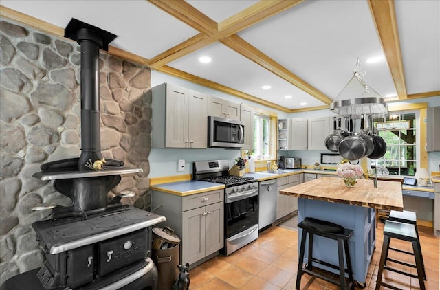 134 Powers Drive Ln, Orland, ME 04472 - kitchen featuring stainless steel appliances, wood counters, beam ceiling, a breakfast bar, and gray cabinets