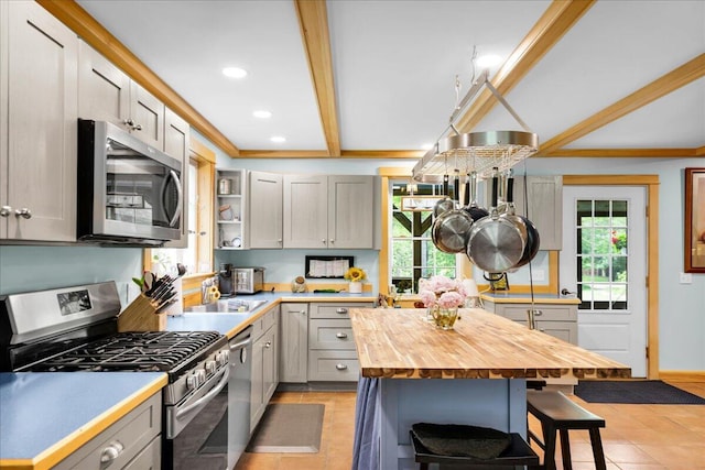 134 Powers Drive Ln, Orland, ME 04472 - kitchen with stainless steel appliances, wood counters, healthy amount of natural light, light tile patterned floors, and recessed lighting