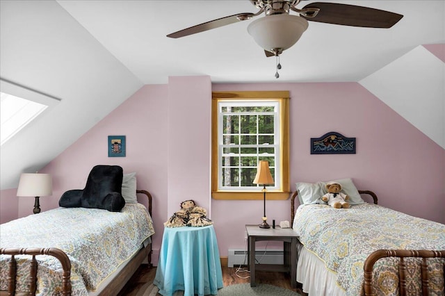 134 Powers Drive Ln, Orland, ME 04472 - bedroom with lofted ceiling, baseboard heating, ceiling fan, wood finished floors, and a skylight