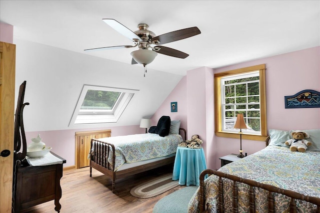 134 Powers Drive Ln, Orland, ME 04472 - bedroom featuring a skylight, light wood-style floors, vaulted ceiling, and ceiling fan