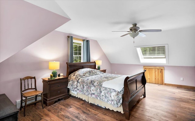 134 Powers Drive Ln, Orland, ME 04472 - bedroom with wood finished floors, lofted ceiling, a ceiling fan, a skylight, and a baseboard heating unit