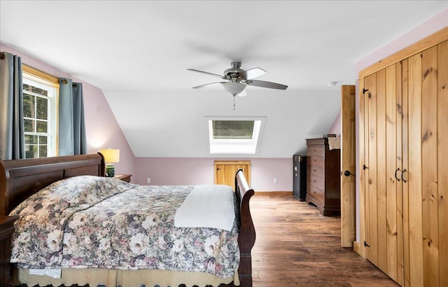 134 Powers Drive Ln, Orland, ME 04472 - bedroom with wood finished floors, vaulted ceiling, ceiling fan, and a skylight
