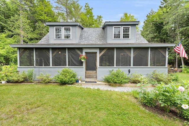 134 Powers Drive Ln, Orland, ME 04472 - view of front of home with a sunroom, a front yard, and a shingled roof