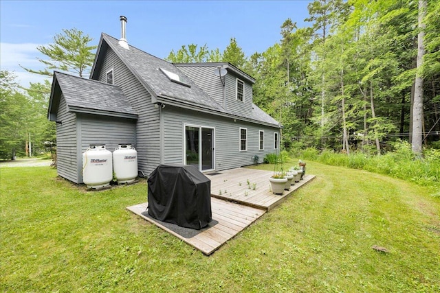 134 Powers Drive Ln, Orland, ME 04472 - rear view of property featuring a deck, a yard, and roof with shingles